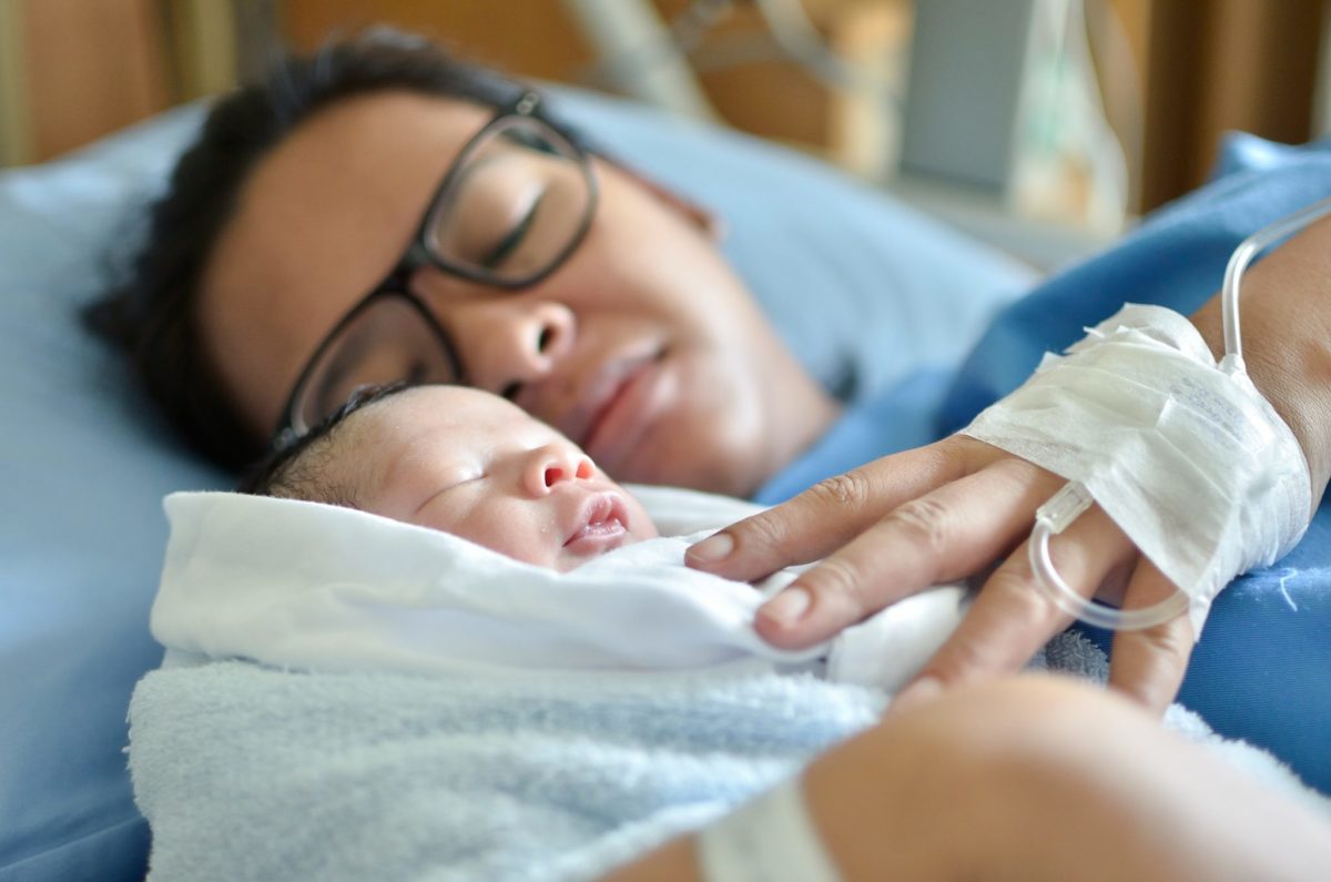 Asian Mom And Baby In Hospital Bed